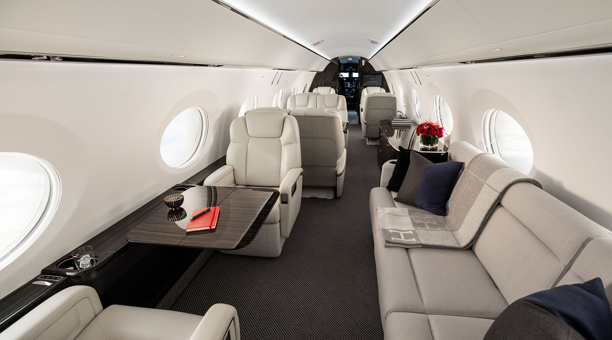 Aircraft cabin interior with divan and a deployed table
