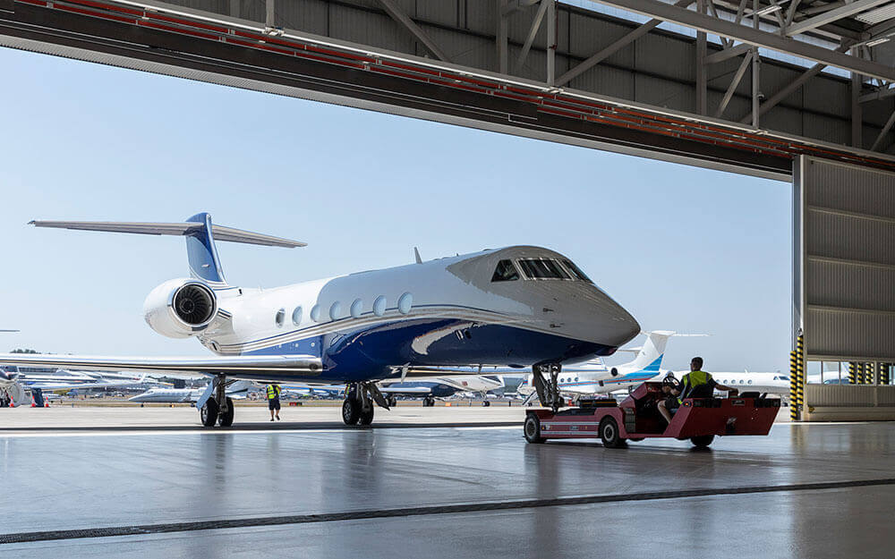 Engineers work in the flight deck of Gulfstream's Iron Bird flight-simulation rig.