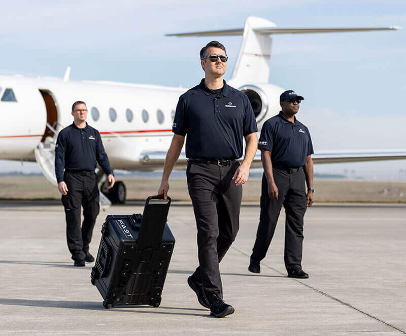 Gulfstream Field and Airborne Support team members disembark from a FAST aircraft.